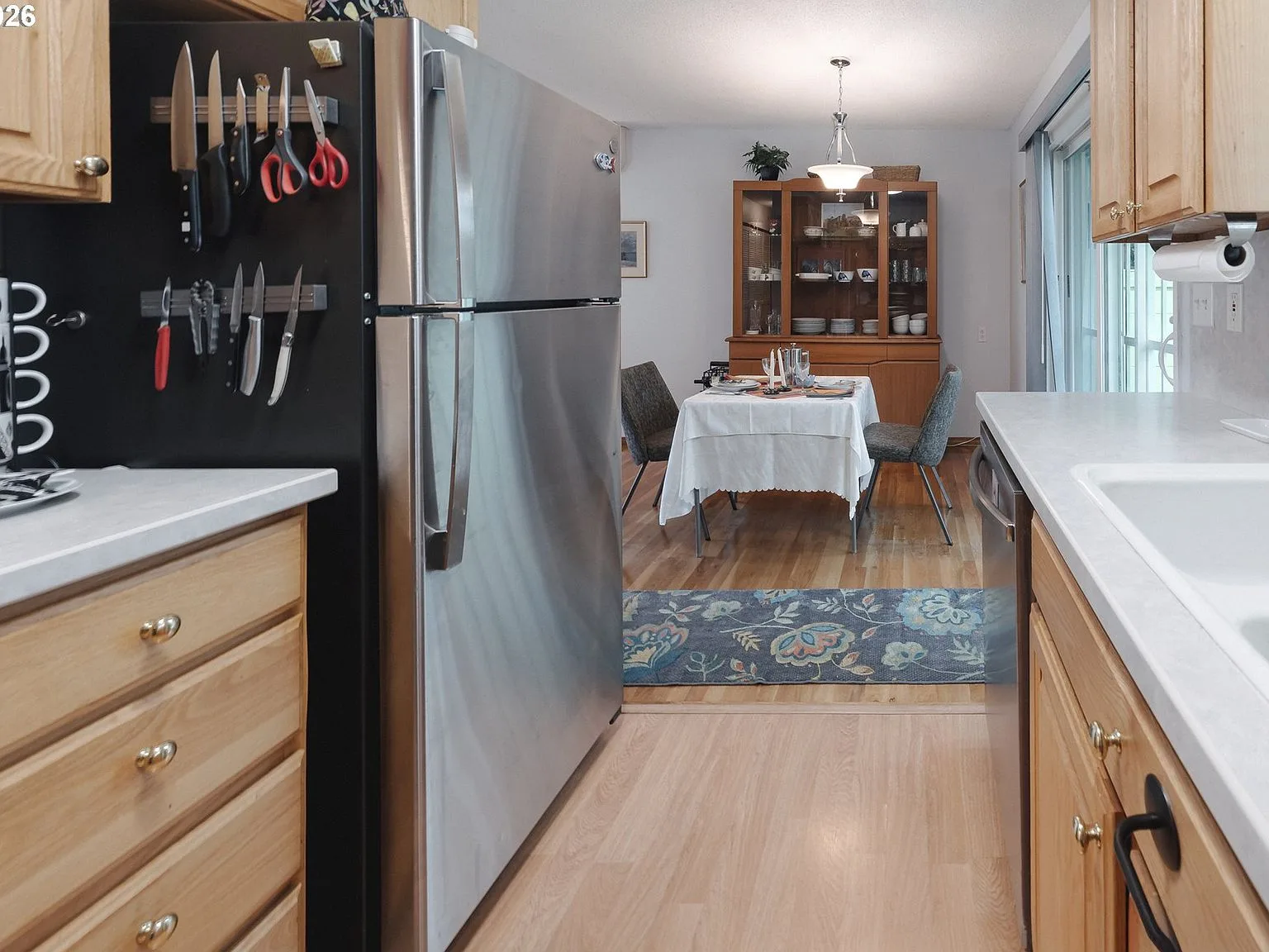 Kitchen looking toward the dining area with light wood cabinetry