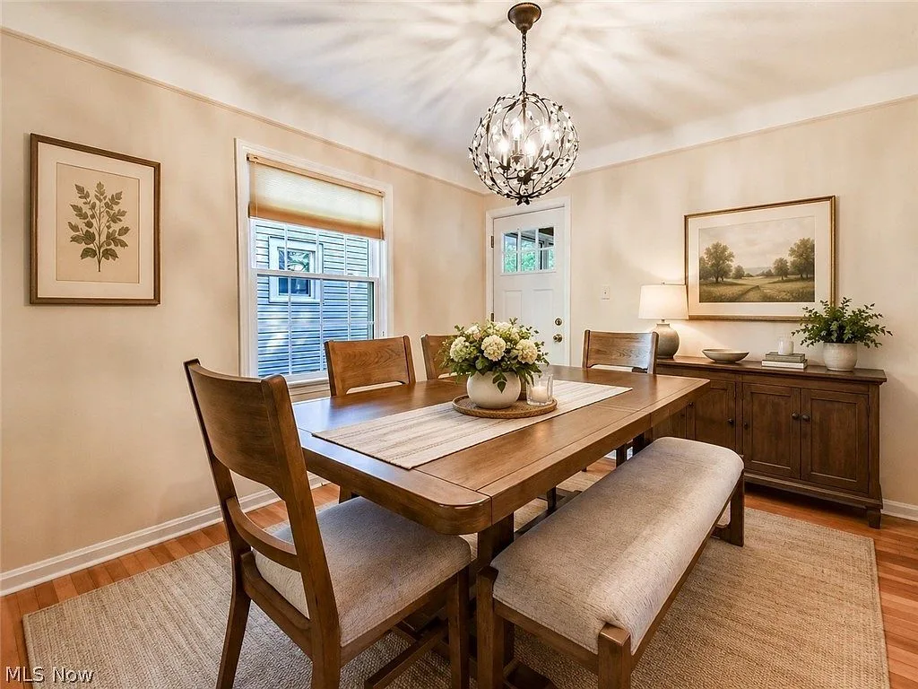 Formal dining room with hardwood floors and natural light