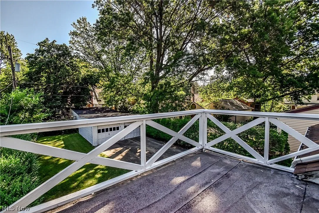 View from upper-level balcony overlooking the backyard and detached garage