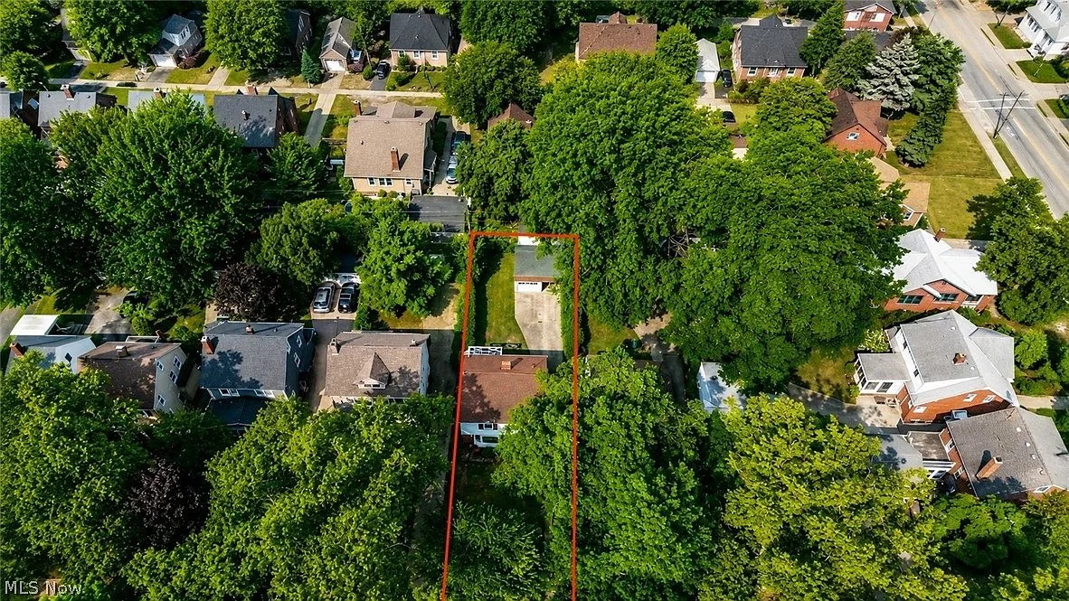 Aerial drone shot of property and surrounding neighborhood with property outline