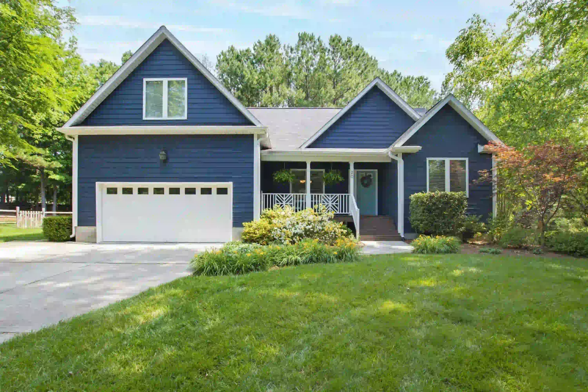 Dark blue siding home with white trim in Durham's Woodcroft neighborhood