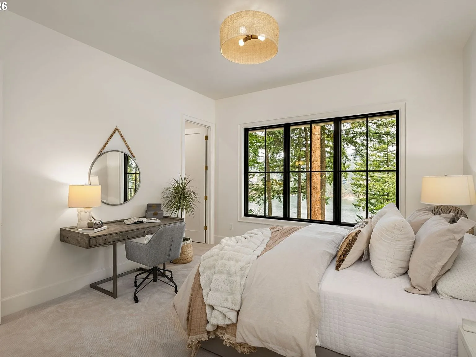 Guest bedroom with large picture window overlooking the woods and lake
