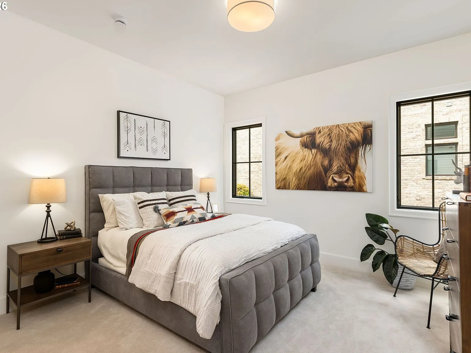 Secondary bedroom in transitional style with neutral palette and black window frames