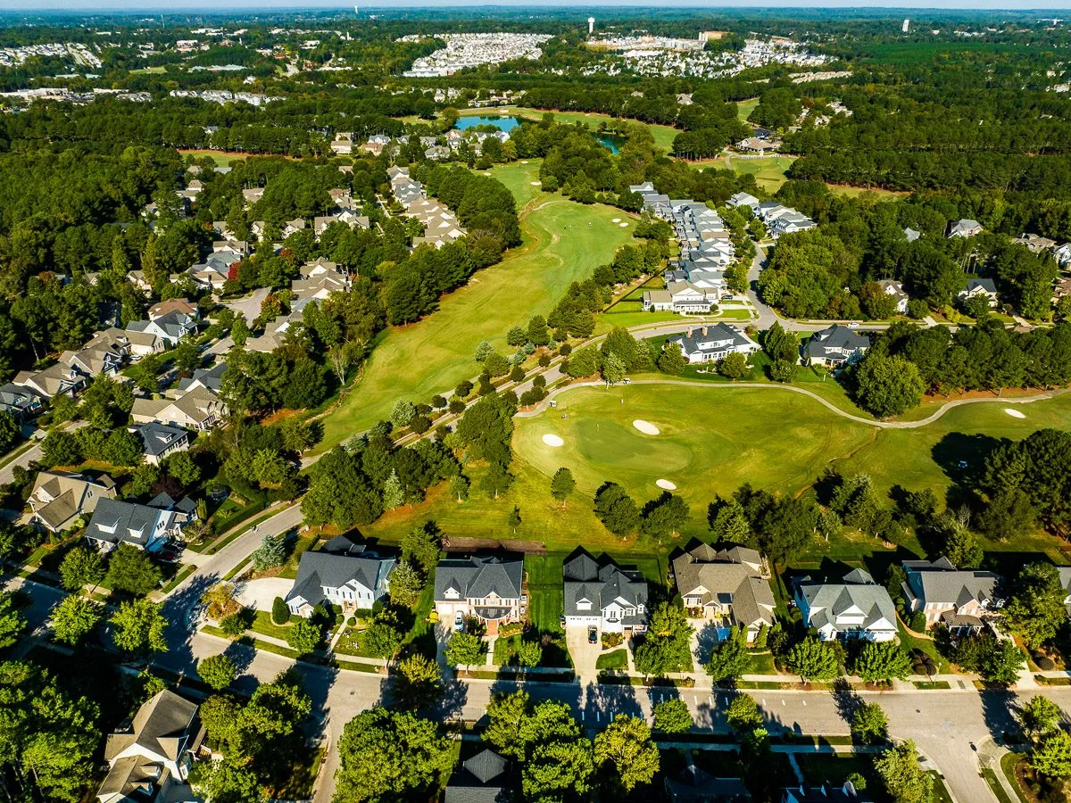 Aerial drone view of Wake Forest with golf course and suburban homes