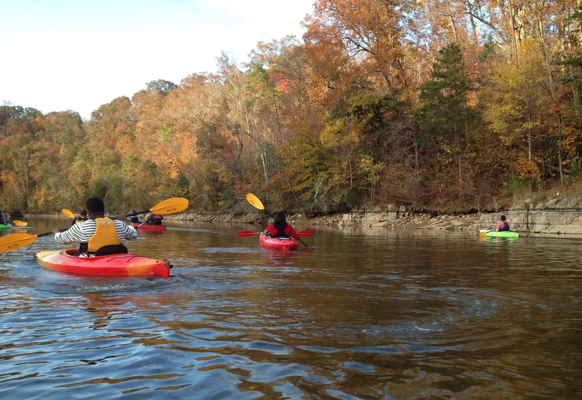 Kayaking on a scenic river surrounded by autumn foliage near Durham