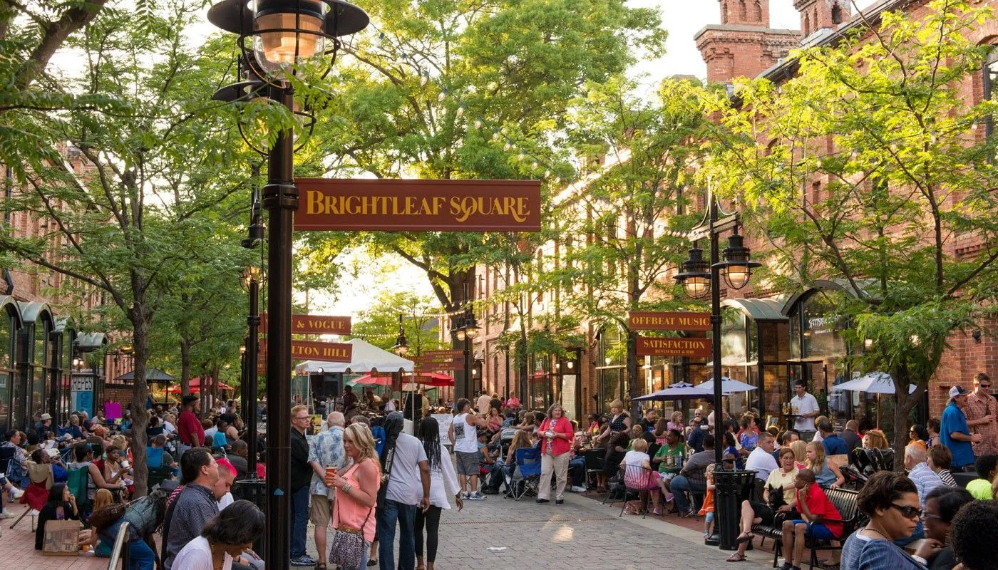Brightleaf Square in downtown Durham with restored brick tobacco warehouses and outdoor plaza seating