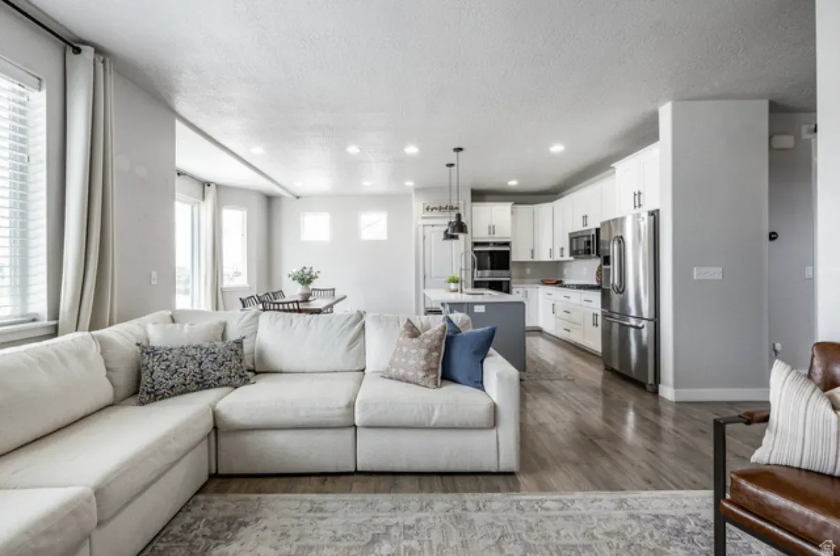 Open-concept living room flowing into the kitchen with LVP flooring