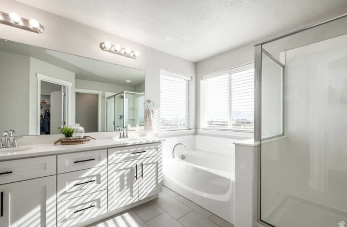 Primary bathroom with soaking tub and glass-enclosed shower
