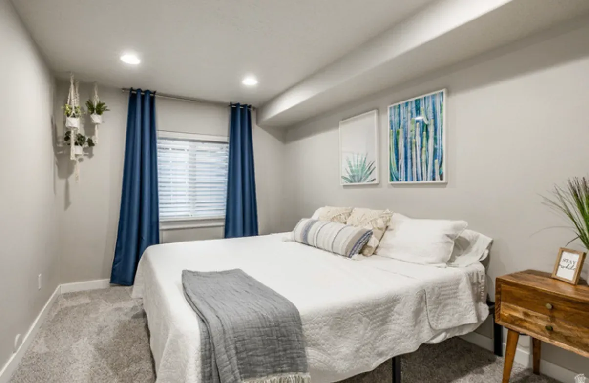 Master bedroom from another angle with king bed, nightstand, and wall art