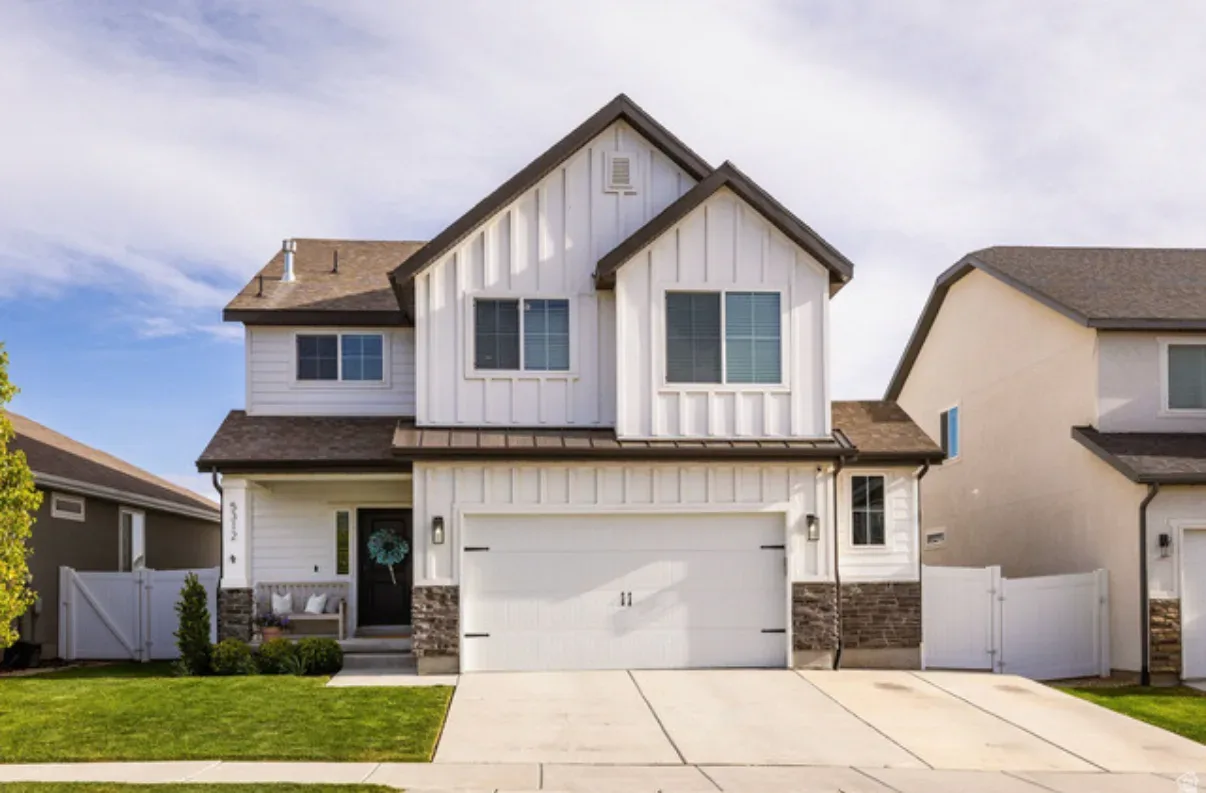 Front exterior of 5312 W Croyden Lane, a modern farmhouse with white board-and-batten siding and stone accents