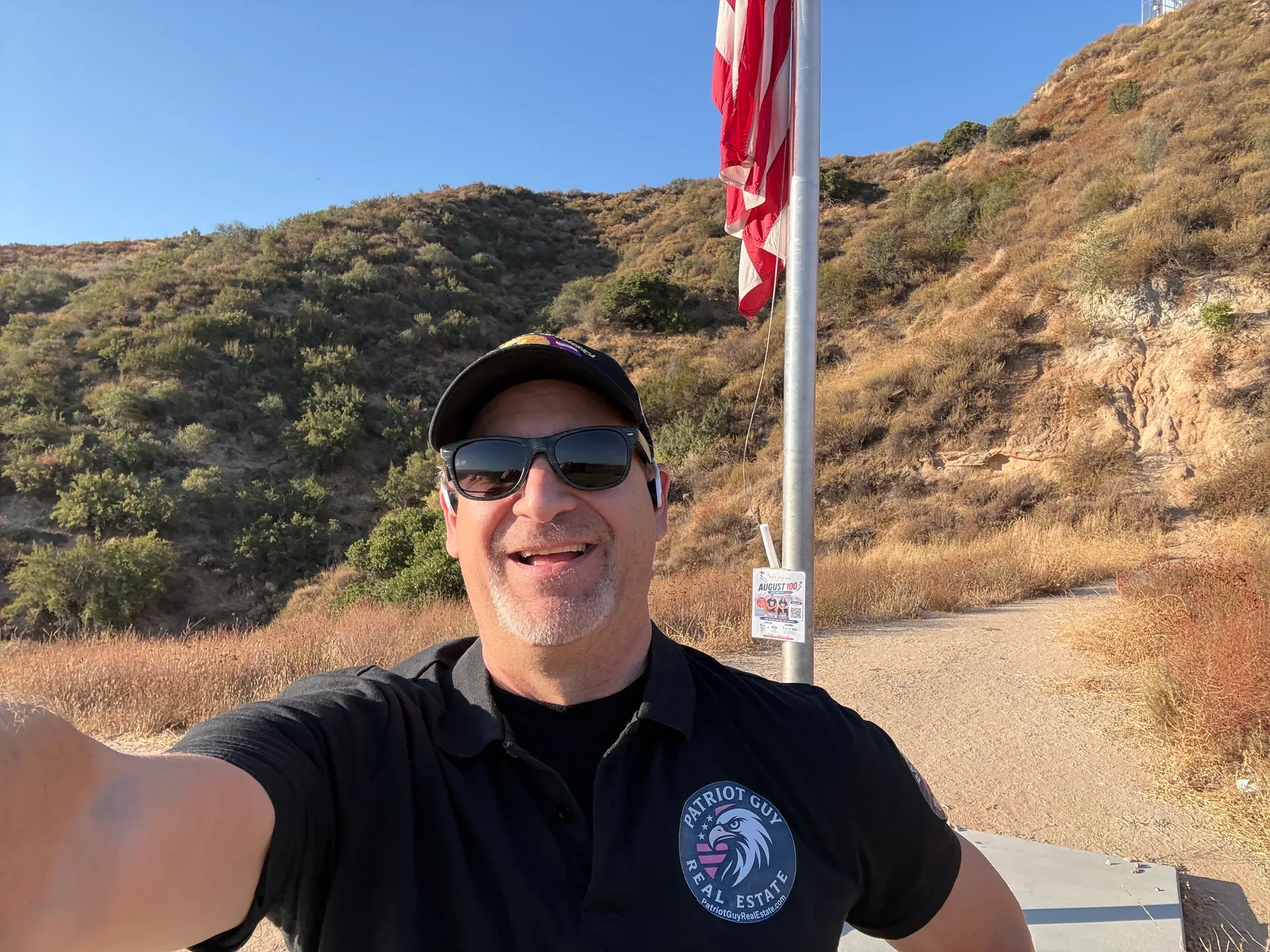 Group of friends at the flagpole overlooking Santa Clarita Valley hills