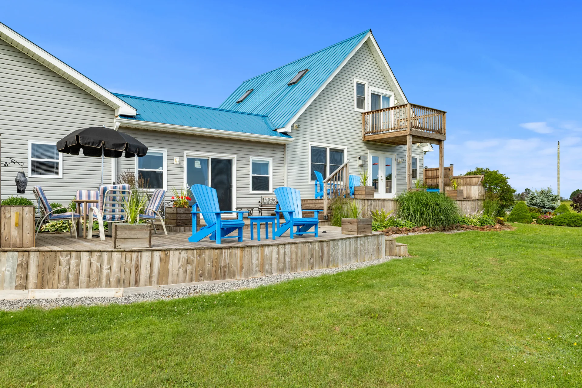 Coastal backyard with deck and outdoor living space