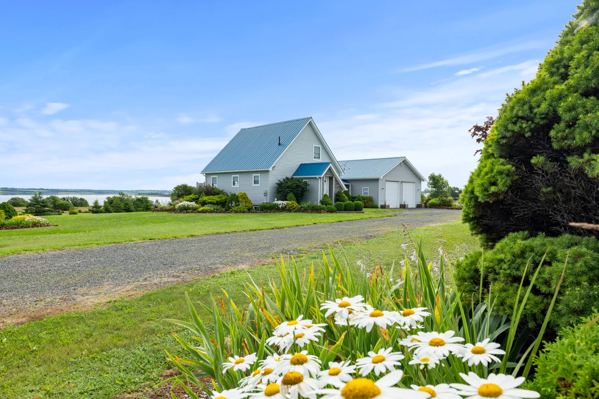 Wide-angle exterior of home and detached garage
