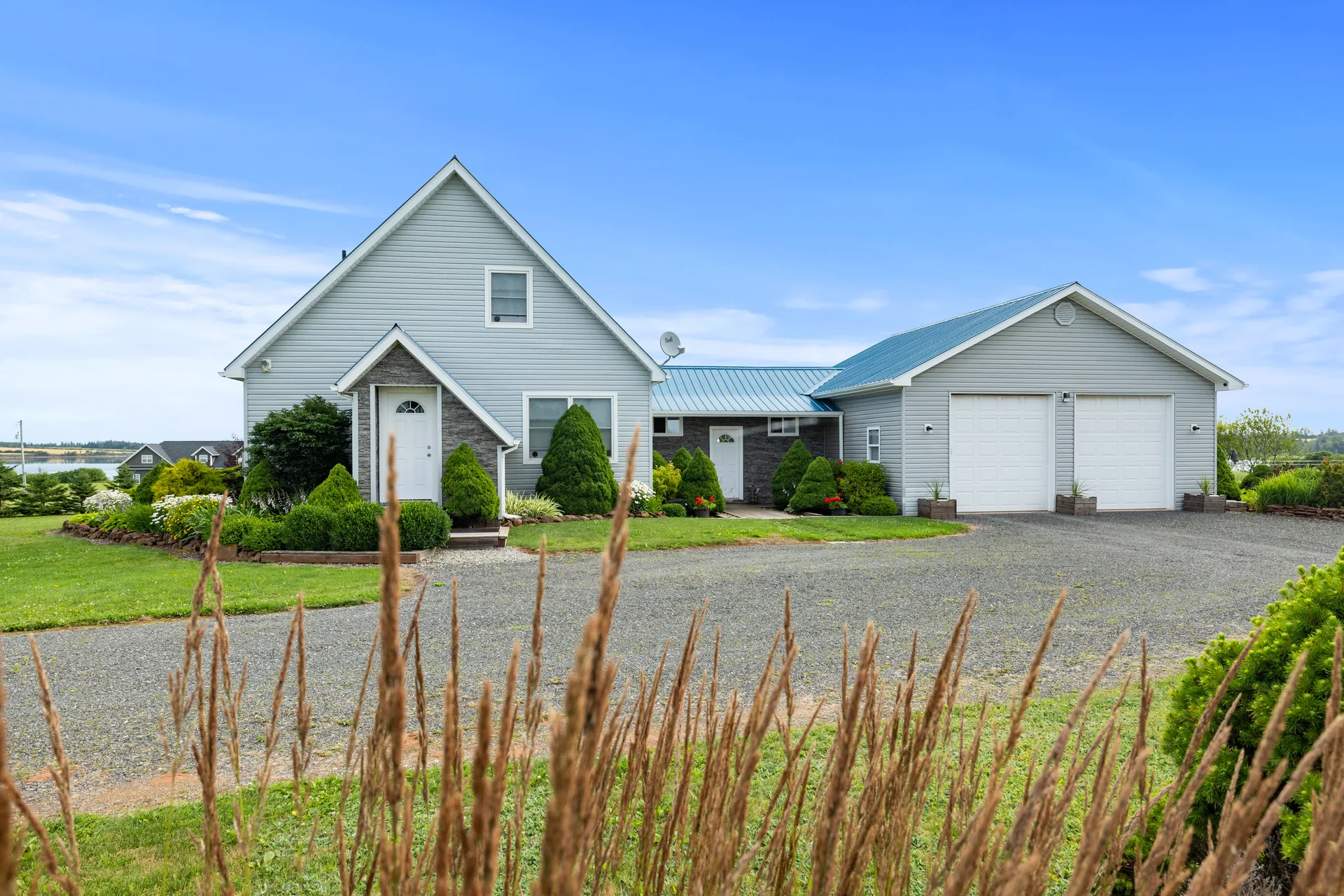 Front facade with landscaped entry and gravel driveway
