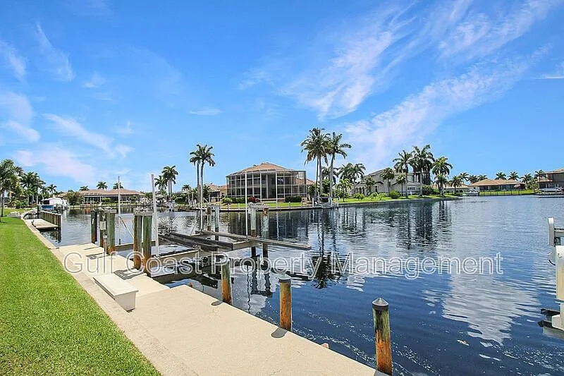 Private boat dock and seawall with palm trees