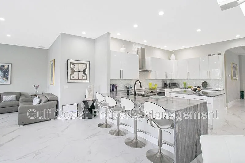 Modern kitchen with waterfall island and white cabinetry