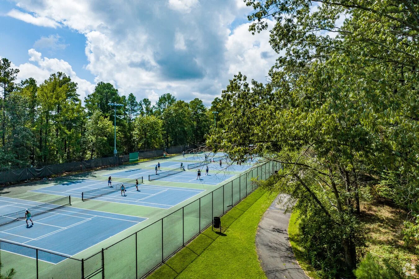 Community tennis courts surrounded by mature trees near Croasdaile Country Club