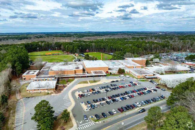 Aerial view of a school campus with athletic fields serving the Downtown Durham area