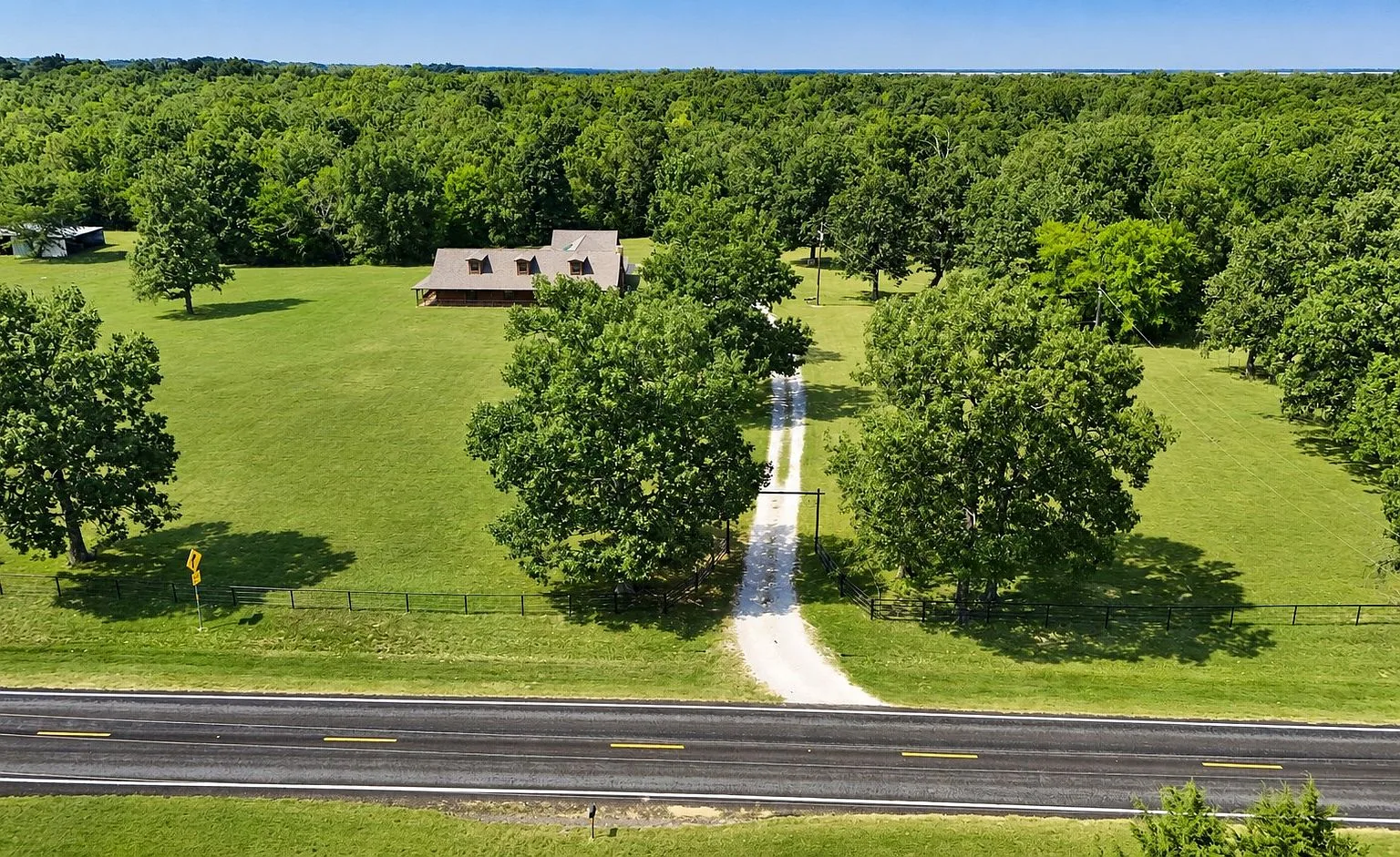 Aerial view of log cabin from the road