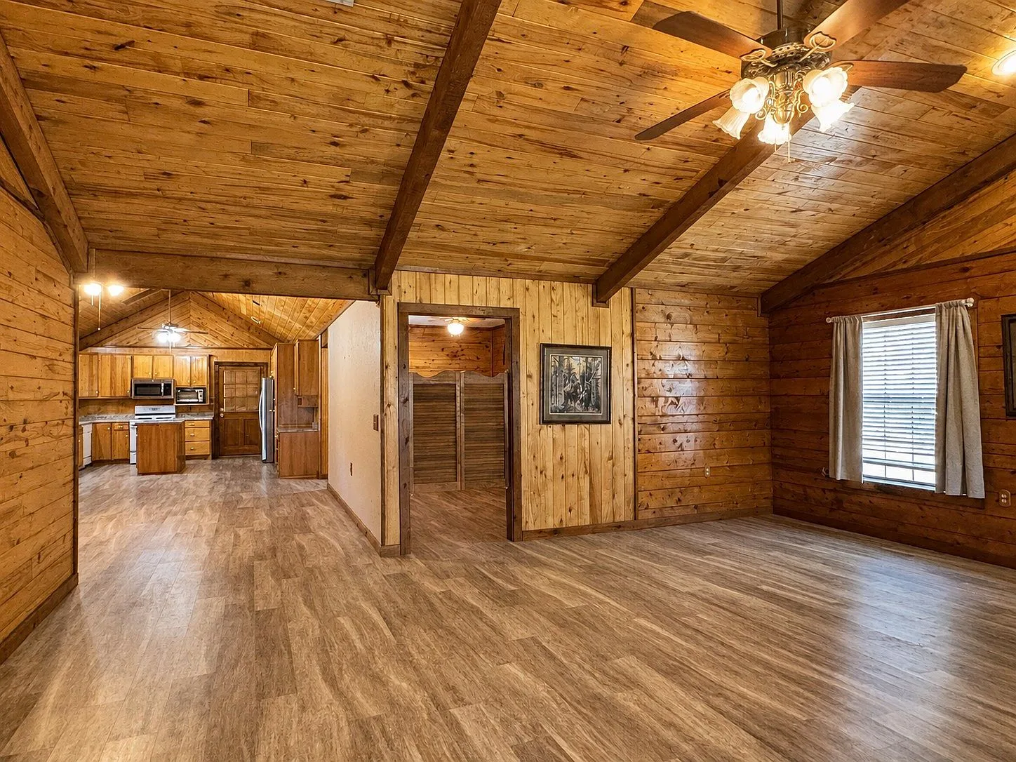 Open concept living area with beamed ceilings