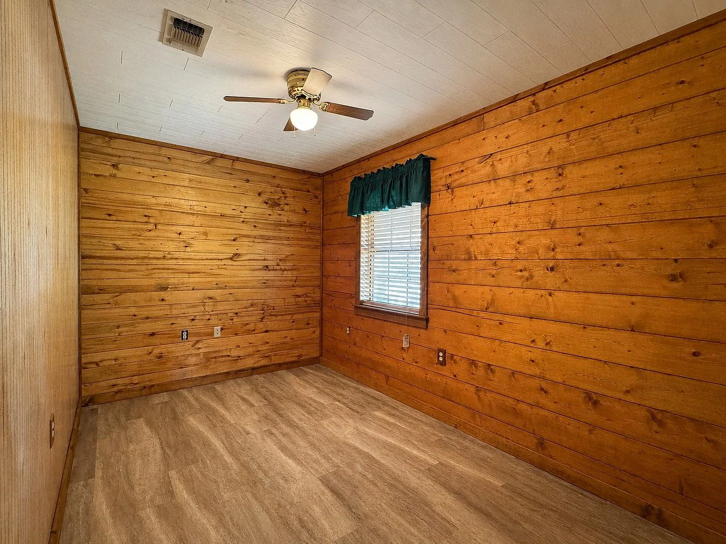 Bedroom with wood-plank walls