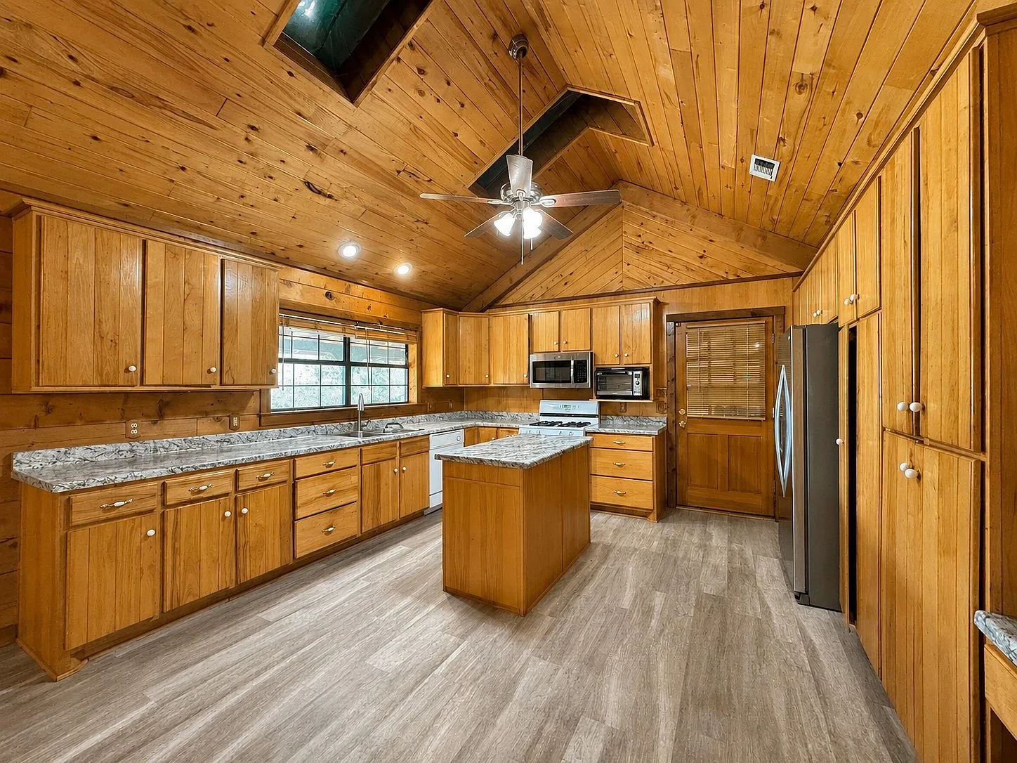 Kitchen with skylights and natural wood cabinetry