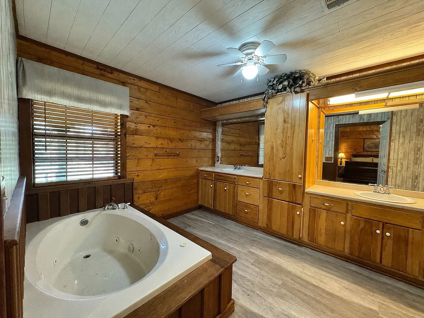 Bathroom with garden tub and wood vanity