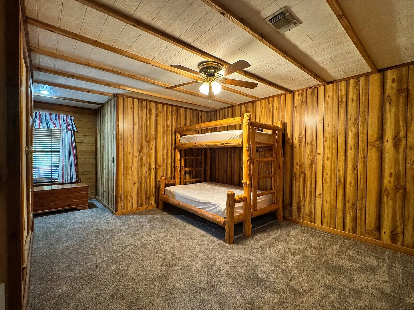 Bedroom with exposed beams and bunk bed
