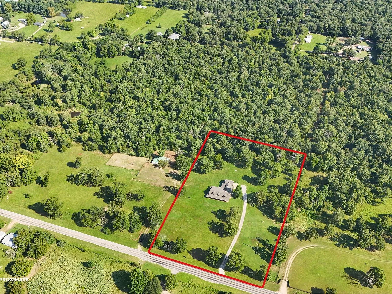 High aerial shot showing property and surrounding trees
