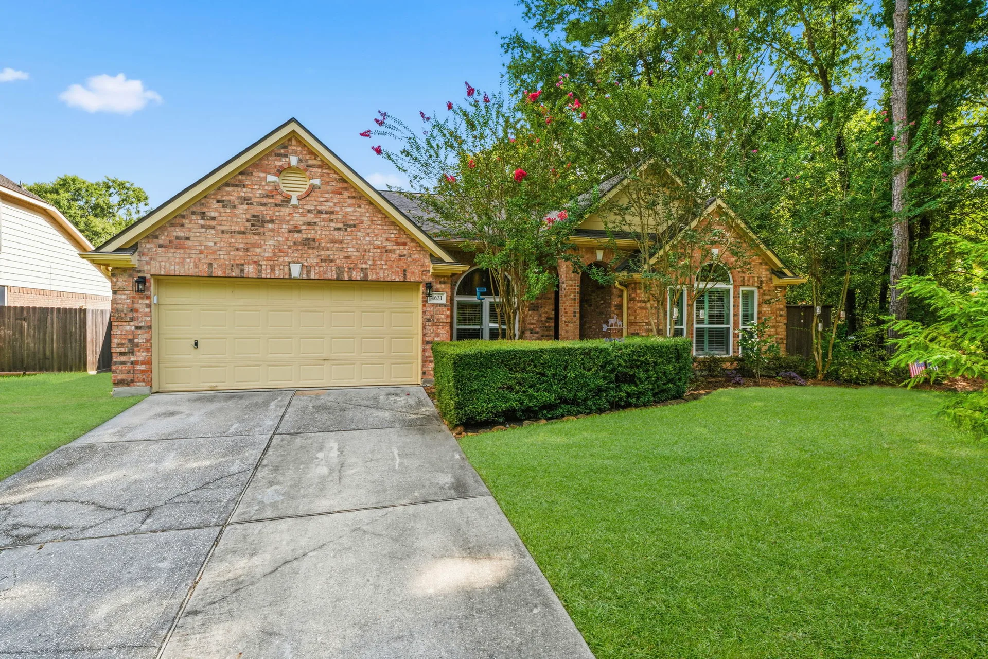 Front exterior of 4631 Windy Gorge Drive, a one-story brick home on a corner lot in Kingwood, TX