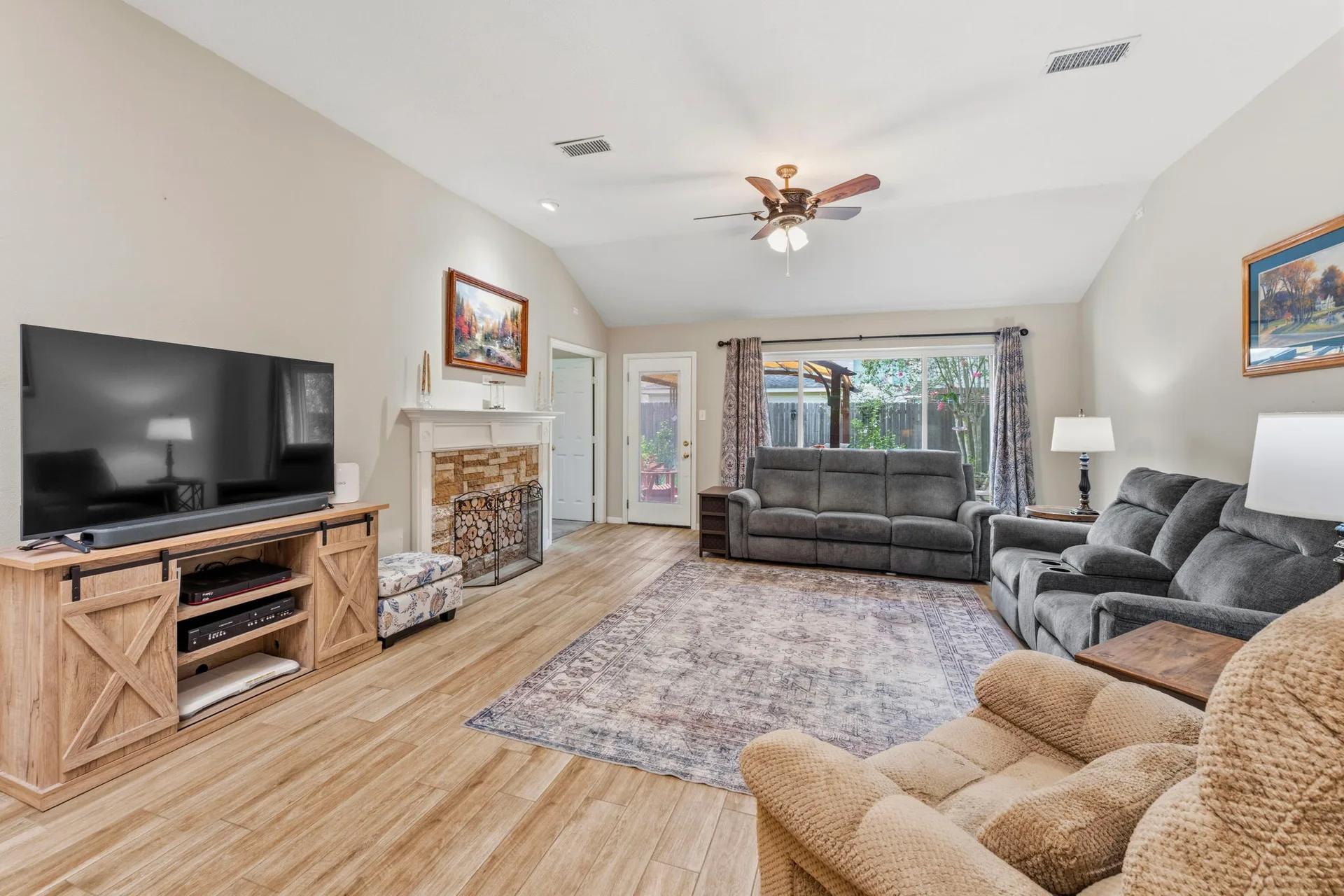Living room with fireplace and vaulted ceilings