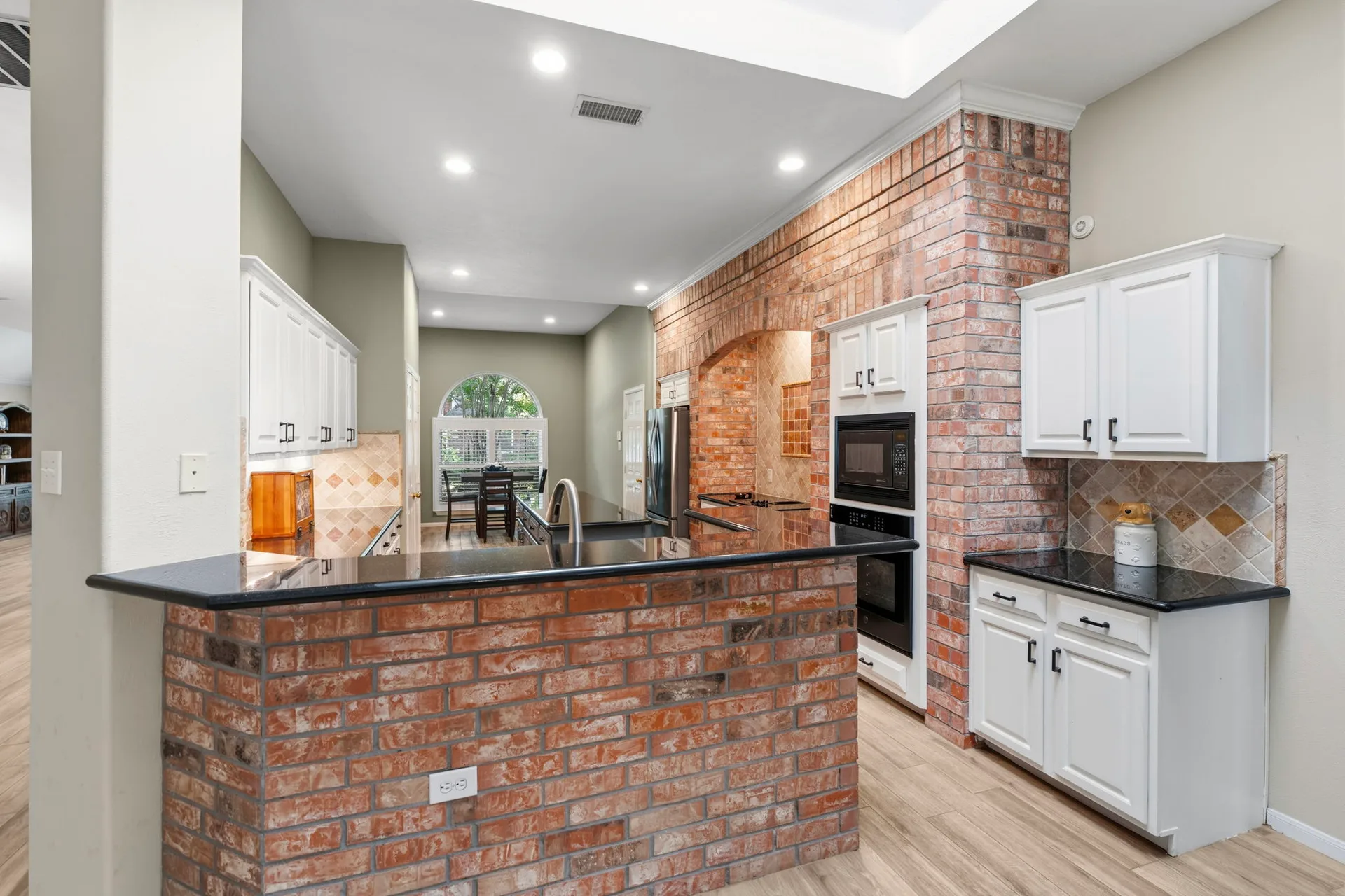 Kitchen with brick arch and granite countertops