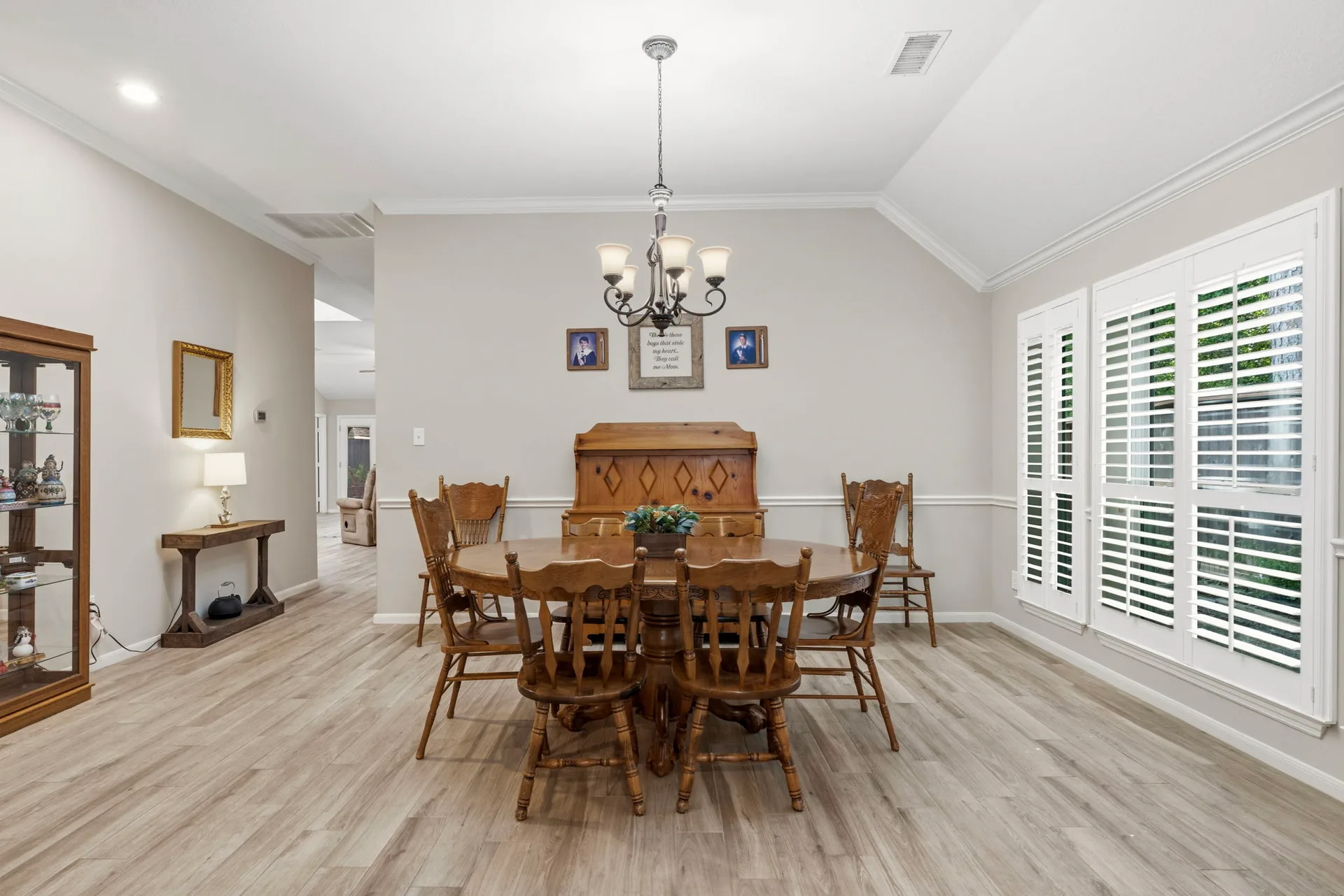 Dining room with plantation shutters and wood-look porcelain tile flooring