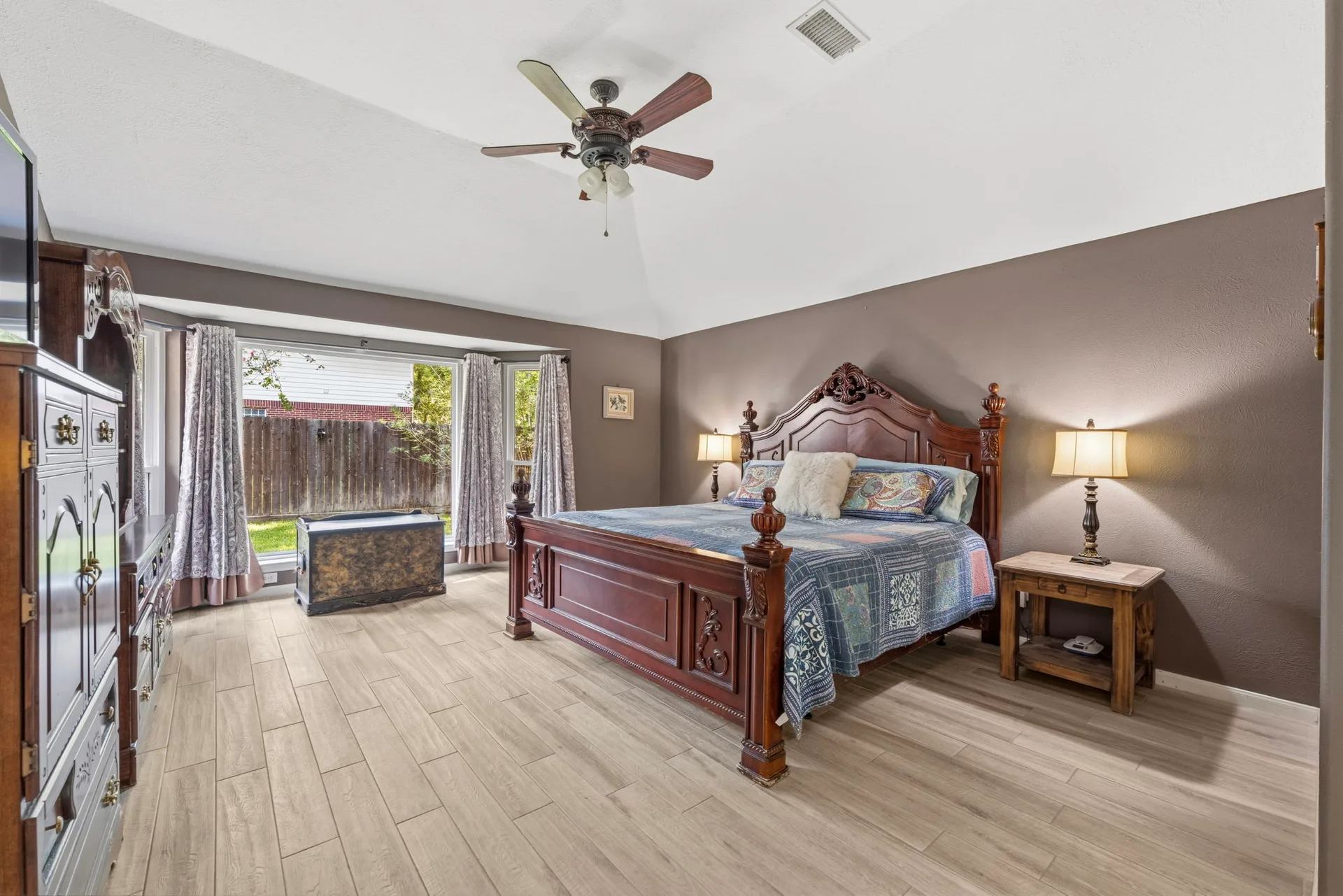 Primary bedroom with vaulted ceilings