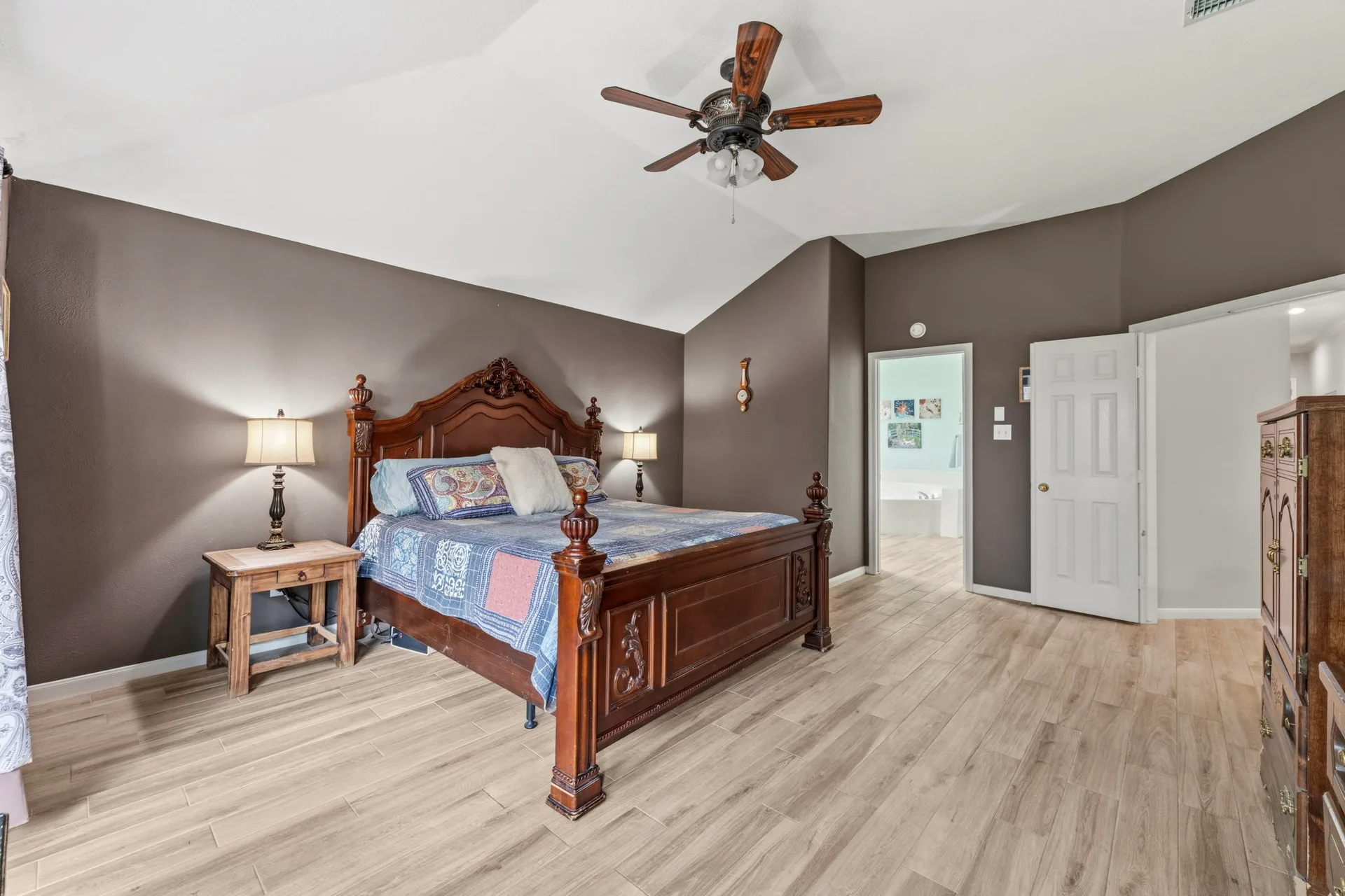 Primary bedroom wide-angle shot showing the spacious layout and natural light
