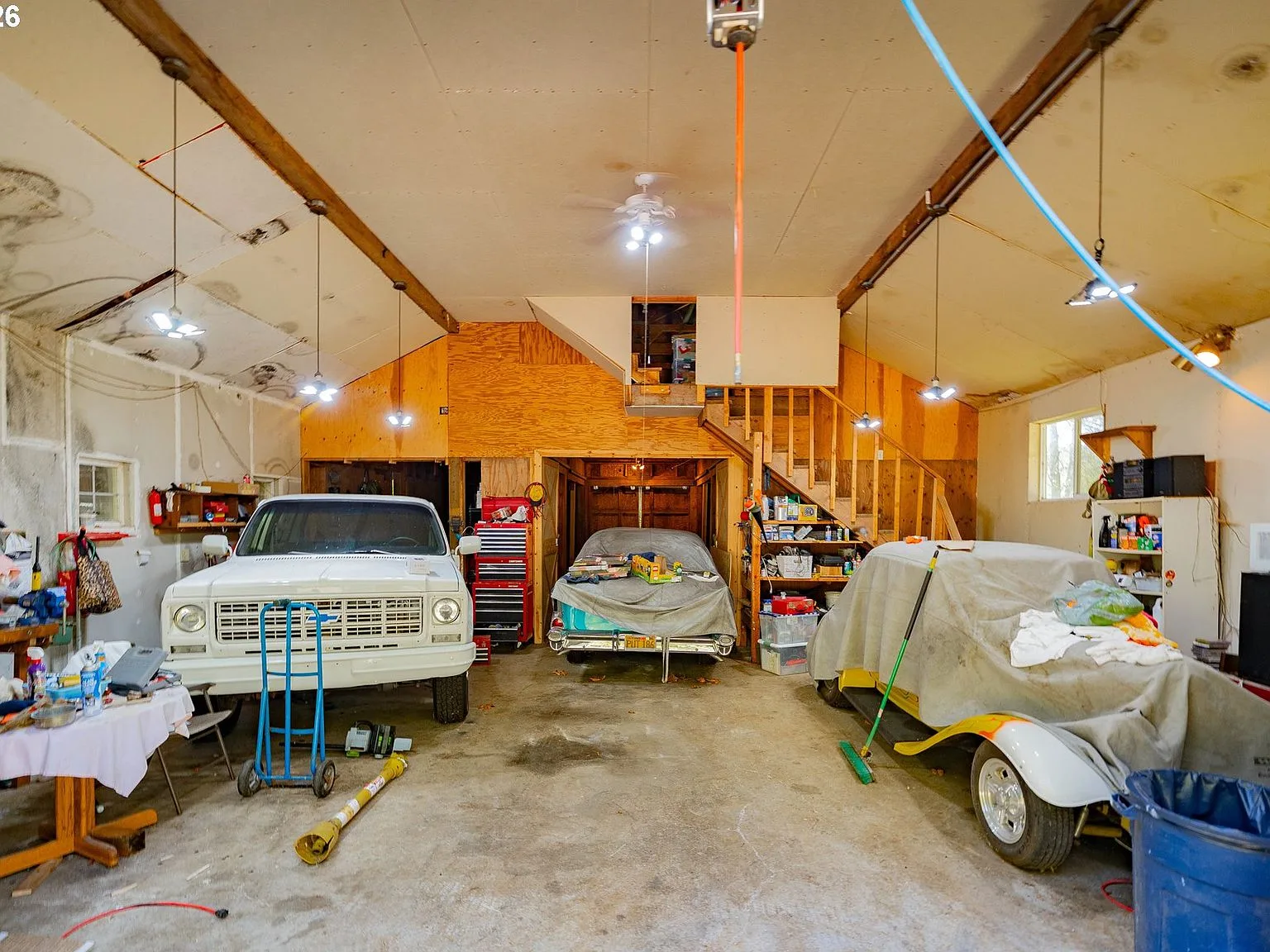 Barn workshop interior with exposed beams and concrete floor
