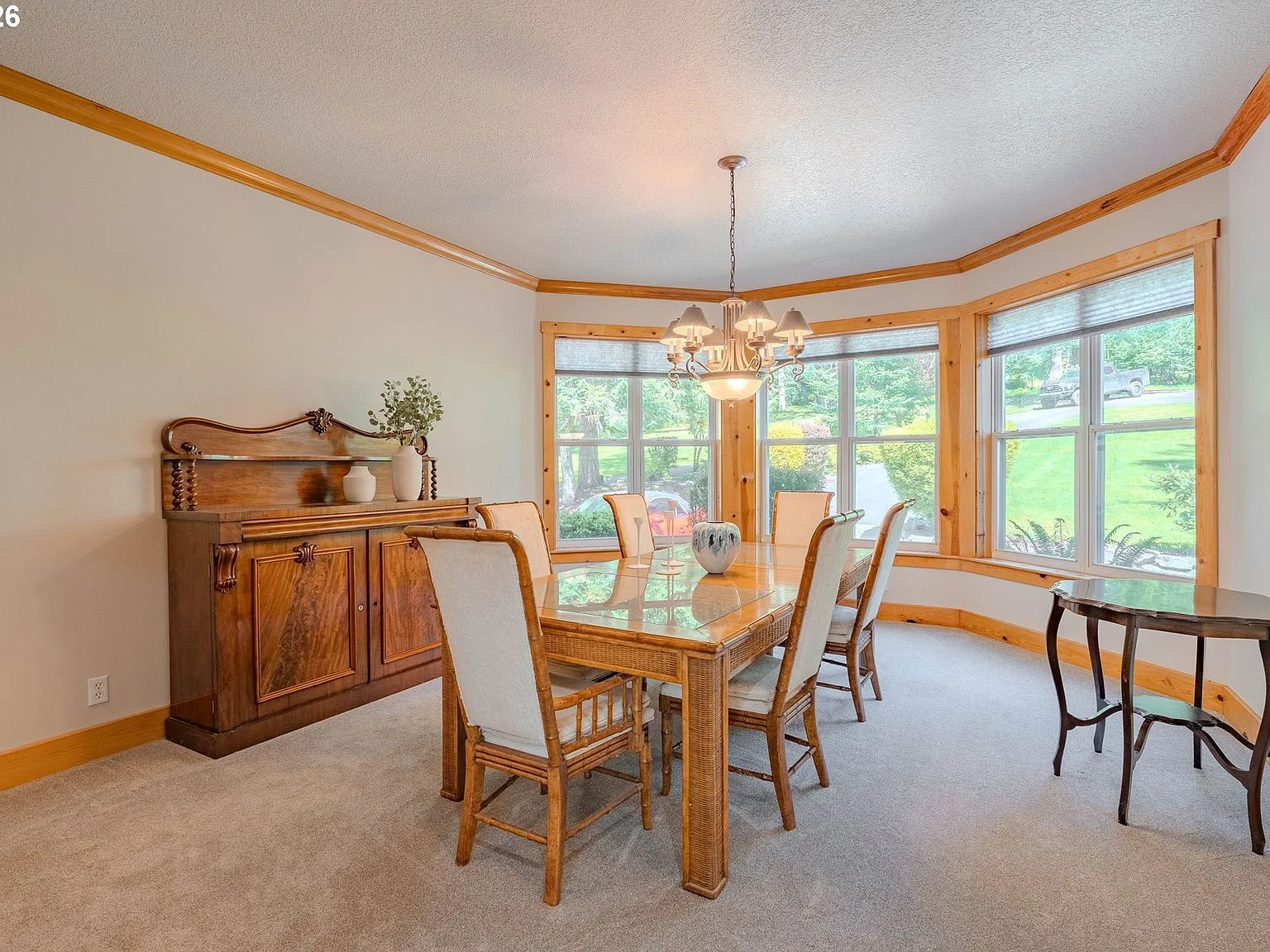 Formal dining room with natural wood trim and bay window