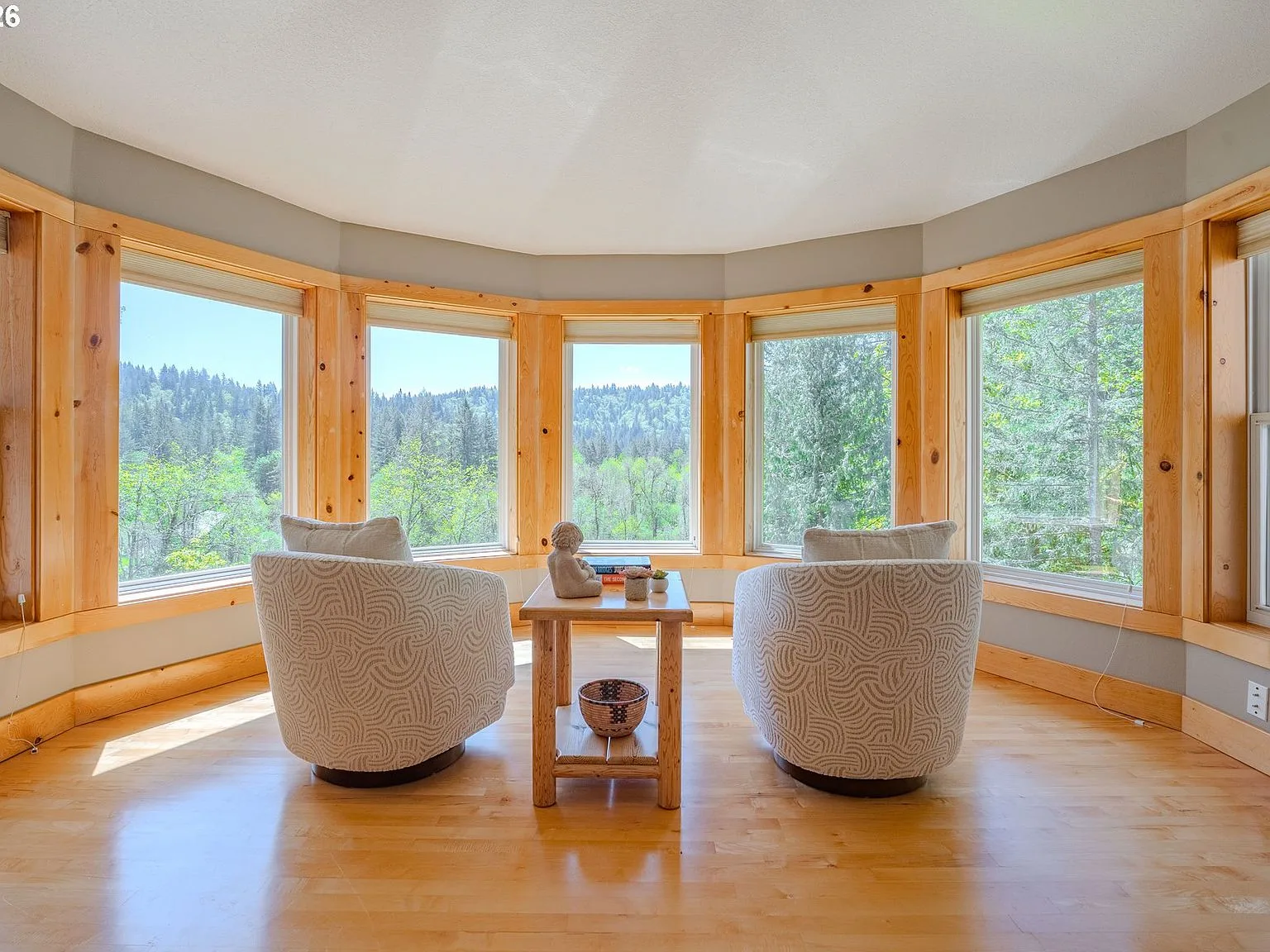 Primary suite sitting area with bay windows and territorial views