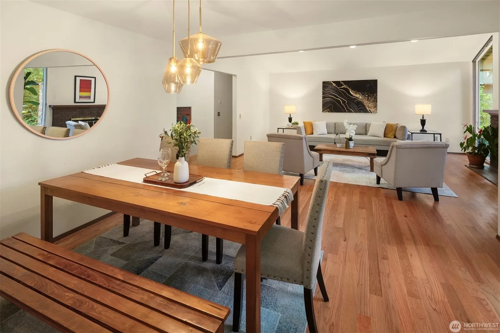Dining area right off the living room, with large windows filling the space with natural light
