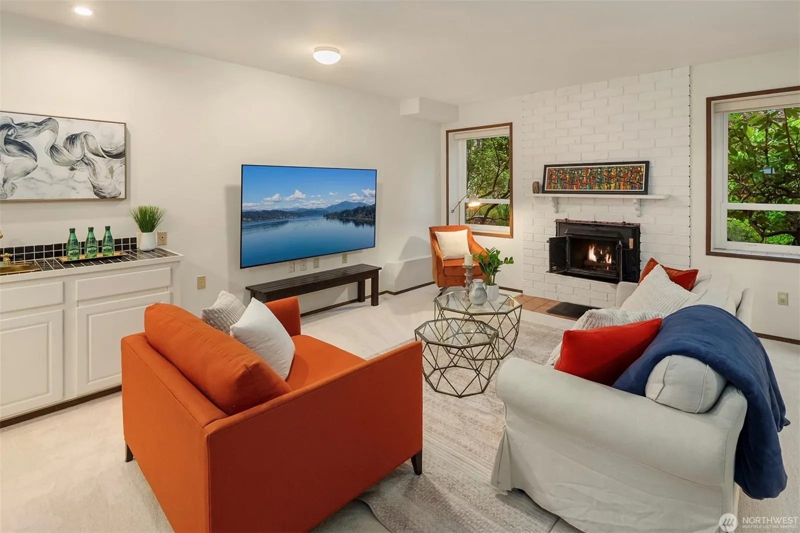 Spacious downstairs family room with white brick fireplace and built-in cabinetry
