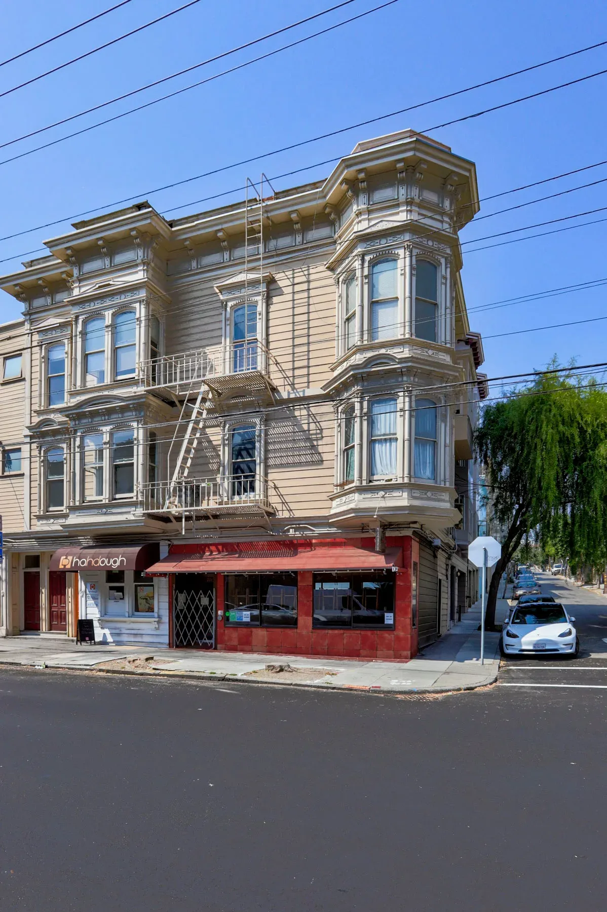 Historic corner building with Victorian architectural details and commercial awnings
