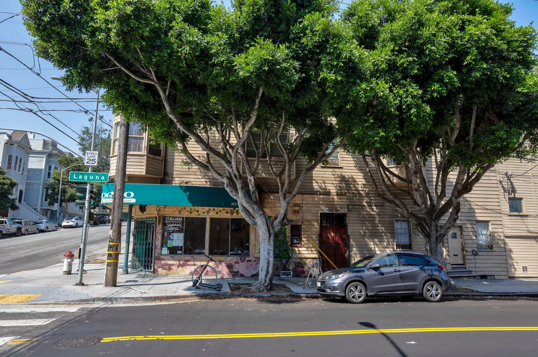 Corner building with green commercial awnings and wood siding