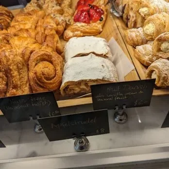 Commercial bakery pastry display with hazelnut twists and apple strudel