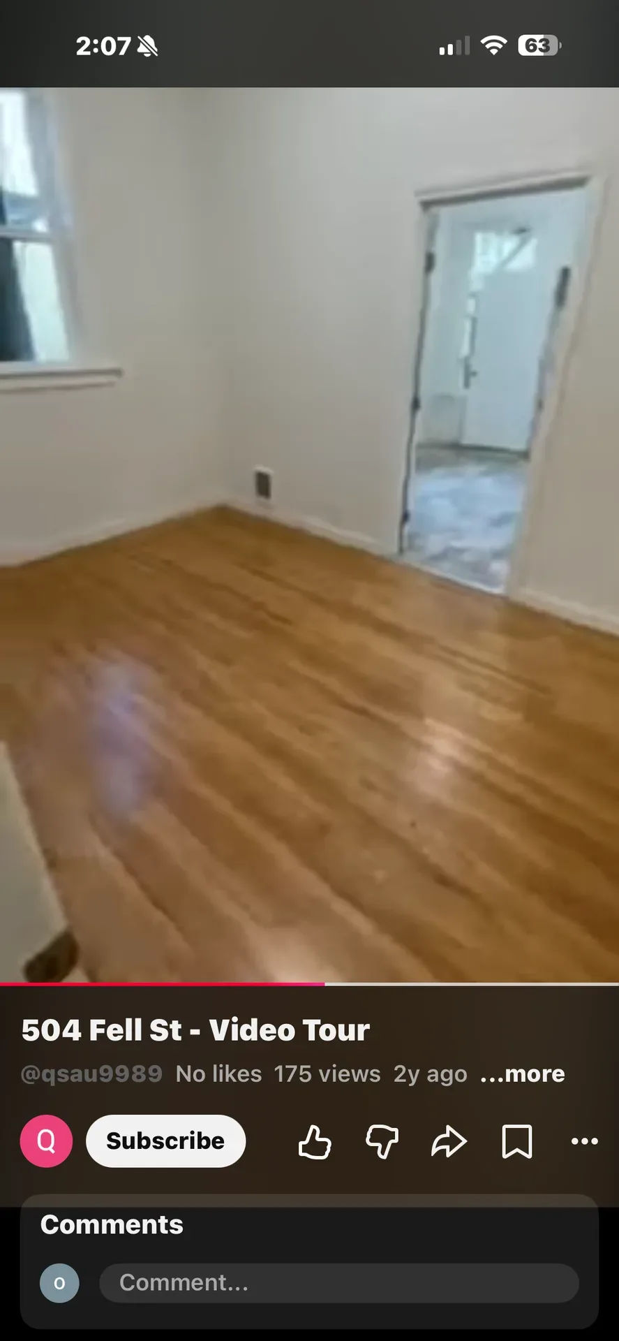 Vacant residential room with light-stained hardwood flooring and white walls