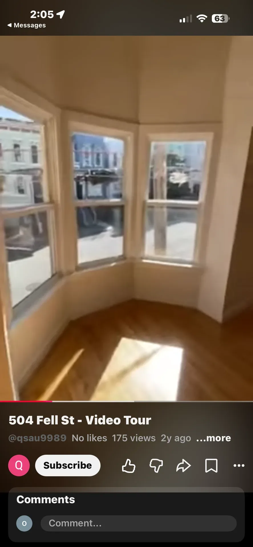 Bright interior room with bay window and light wood flooring