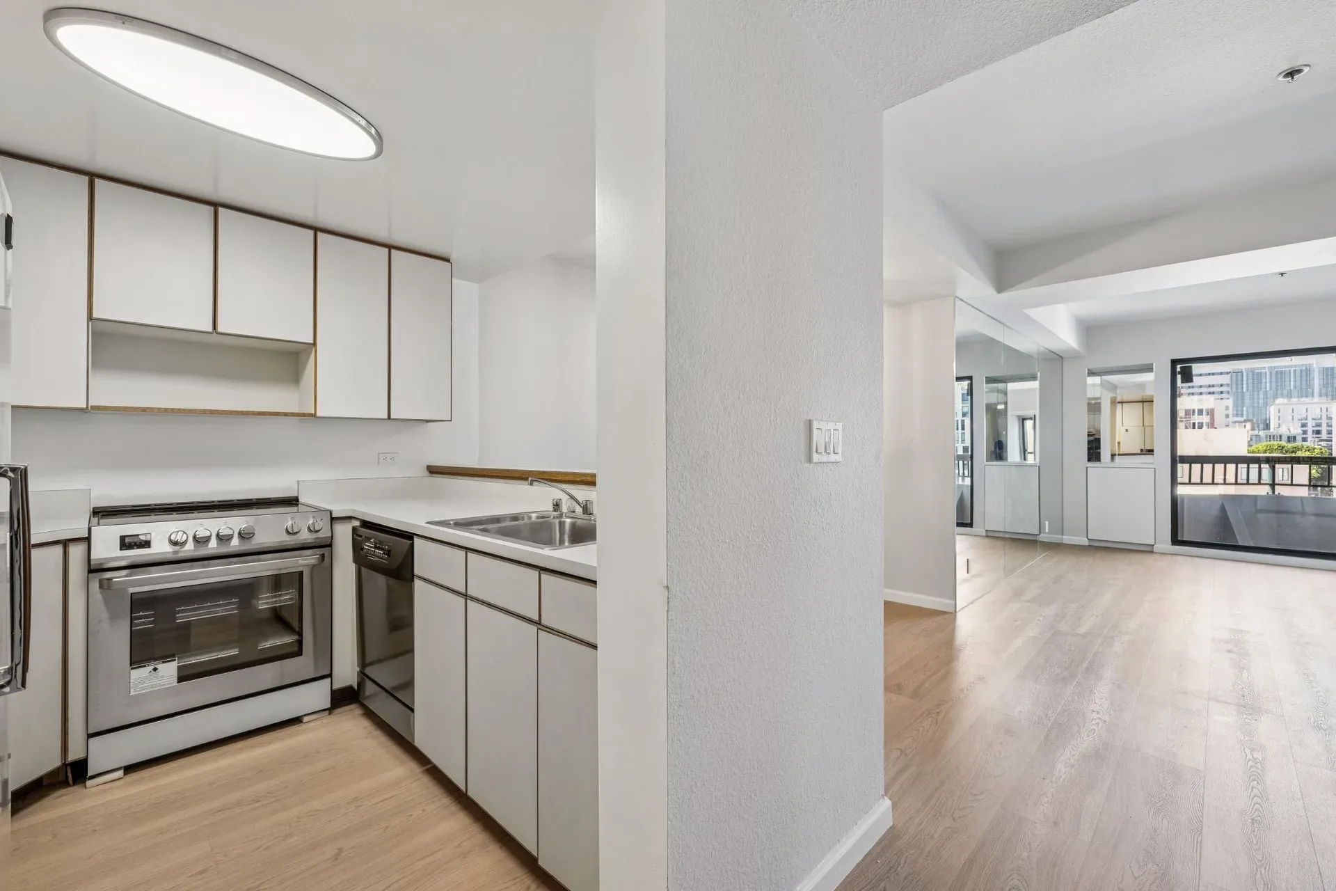 Updated kitchen with white cabinetry and stainless steel appliances at 601 Van Ness