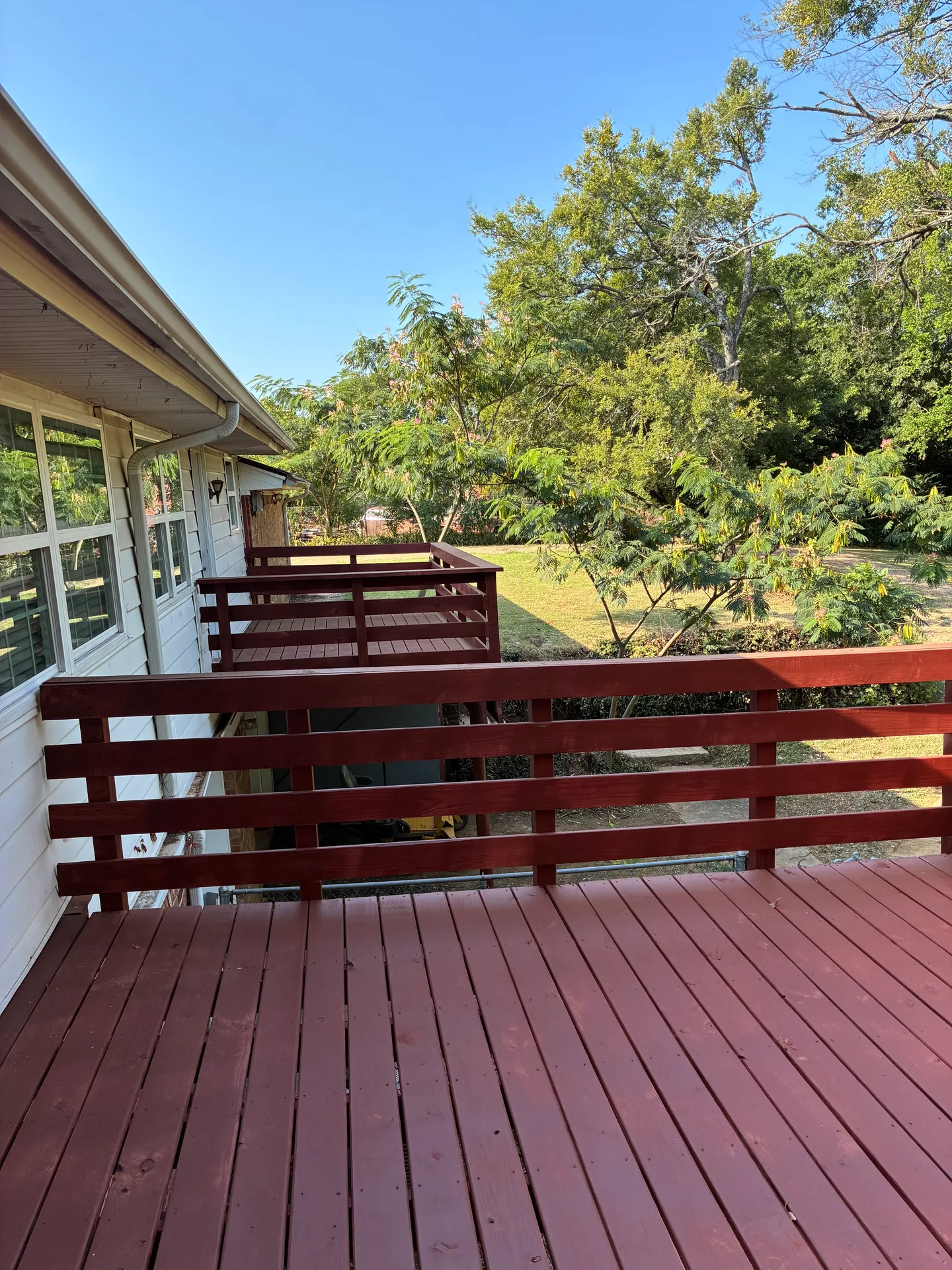 Rear of the home with two elevated decks overlooking the private wooded backyard