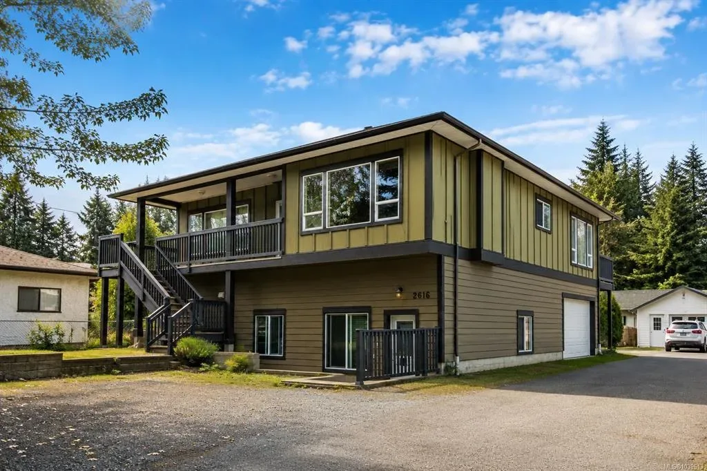Exterior front facade second angle showing the home entrance and upper deck