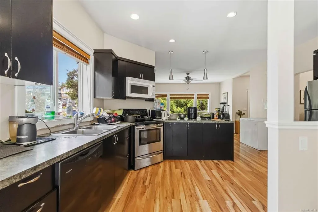 Main-floor kitchen shown with current countertop appliances and daily items
