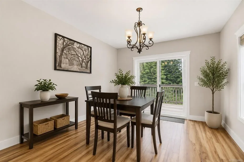 Dining area with table and chairs set near sliding glass door opening to the deck